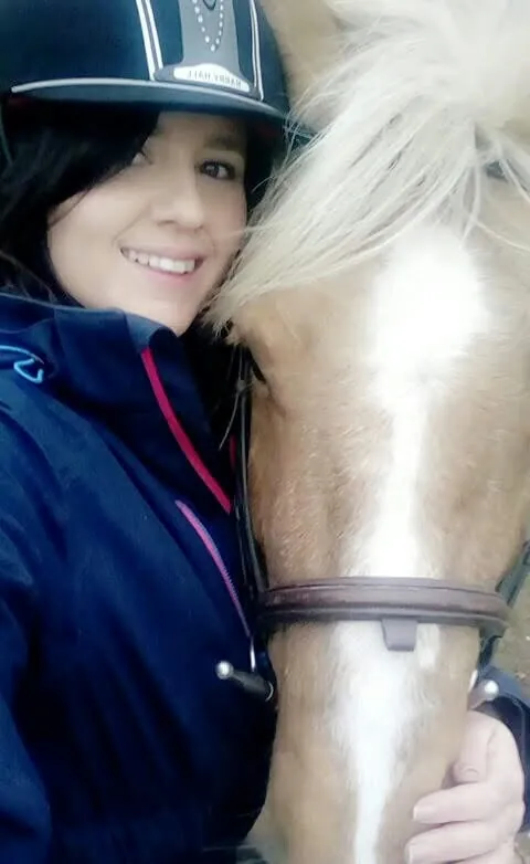 Amber cheek to cheek with one of her horses